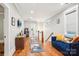 Hallway with hardwood floors and a blue velvet couch at 2315 Dundeen St, Charlotte, NC 28216
