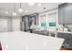 Kitchen featuring stainless steel appliances, grey cabinets, subway tile backsplash, and large island at 2315 Dundeen St, Charlotte, NC 28216