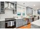 Kitchen featuring stainless steel appliances, grey cabinets, subway tile backsplash and modern design at 2315 Dundeen St, Charlotte, NC 28216
