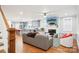 Open-concept living area with hardwood floors, fireplace, and modern kitchen in the background at 2315 Dundeen St, Charlotte, NC 28216