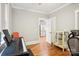 Home office with a piano, hardwood floors, and access to the kitchen at 2315 Dundeen St, Charlotte, NC 28216