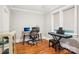 Home office with a computer desk, piano, and hardwood floors at 2315 Dundeen St, Charlotte, NC 28216