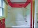 White tiled bathroom with vintage gold shower fixtures and a soaking tub at 2326 Armstrong Cir, Gastonia, NC 28054