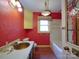 Unique bathroom with red walls, gold fixtures, and a vintage vanity sink at 2326 Armstrong Cir, Gastonia, NC 28054