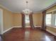 Elegant dining room featuring a chandelier, hardwood floors, and ample natural light at 2326 Armstrong Cir, Gastonia, NC 28054