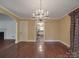 Open-concept dining area with hardwood floors, chandelier, and seamless flow to the kitchen at 2326 Armstrong Cir, Gastonia, NC 28054