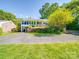 Charming home featuring a sunroom, covered porch, and vibrant landscaping at 2326 Armstrong Cir, Gastonia, NC 28054