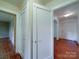 Hallway features wood floors, white trim, and classic paneled doors at 2326 Armstrong Cir, Gastonia, NC 28054