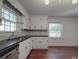 Bright kitchen features black countertops, dark hardware, and a stainless steel sink at 2326 Armstrong Cir, Gastonia, NC 28054