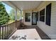 Covered front porch with a wooden railing, offering a welcoming entrance to the home at 2326 Armstrong Cir, Gastonia, NC 28054