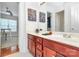 Bathroom featuring cherry wood cabinets, double sinks, and modern fixtures at 2425 Orofino Ct, Charlotte, NC 28269