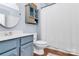 Charming bathroom featuring blue vanity, updated fixtures, and hardwood flooring at 2425 Orofino Ct, Charlotte, NC 28269