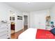 Bedroom with wood floors, a white and red bed, and an attached bathroom at 2425 Orofino Ct, Charlotte, NC 28269