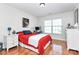 Bright bedroom with hardwood floors, featuring a red bed and natural light from the window at 2425 Orofino Ct, Charlotte, NC 28269