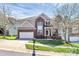 Inviting two-story home featuring a brick facade, manicured lawn, and a two-car garage at 2425 Orofino Ct, Charlotte, NC 28269
