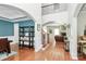 Open foyer with hardwood floors, staircase, and an archway leading into the living room at 2425 Orofino Ct, Charlotte, NC 28269