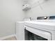 Well-lit laundry room with modern white washer and dryer units at 2425 Orofino Ct, Charlotte, NC 28269