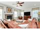 Spacious living room with hardwood floors, a fireplace, and a ceiling fan at 2425 Orofino Ct, Charlotte, NC 28269
