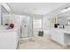 Bright main bathroom features double vanity, walk-in shower and tub, creating a spa-like atmosphere at 2425 Orofino Ct, Charlotte, NC 28269