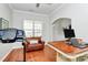 Comfortable office space with hardwood floors, a leather couch, and a large window at 2425 Orofino Ct, Charlotte, NC 28269