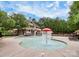 Community pool area featuring water features and lounging chairs, perfect for summer relaxation and recreation at 2425 Orofino Ct, Charlotte, NC 28269