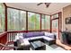 Inviting screened-in porch featuring comfortable wicker furniture and serene backyard views at 2425 Orofino Ct, Charlotte, NC 28269