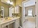 Bright bathroom featuring a vanity with sink, cabinets, and a separate bathtub with window at 2516 Middlebridge Ln, Charlotte, NC 28270