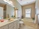 Serene bathroom featuring a vanity with sink, a bathtub, and neutral decor, enhanced by natural light at 2516 Middlebridge Ln, Charlotte, NC 28270