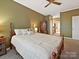 Comfortable bedroom with a wooden bed frame, neutral walls, carpet, and an ensuite bathroom access at 2516 Middlebridge Ln, Charlotte, NC 28270