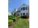 Charming two-story home with manicured lawn and beautiful landscaping, including lush green bushes at 2516 Middlebridge Ln, Charlotte, NC 28270