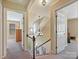 Hallway with stairs and open doorways, showcasing the home's layout and accessibility at 2516 Middlebridge Ln, Charlotte, NC 28270