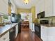 Kitchen featuring stainless steel appliances, granite countertops, and hardwood floors leading to dining area at 2516 Middlebridge Ln, Charlotte, NC 28270