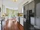 Bright kitchen with white cabinets, hardwood floors, and a dining nook at 2516 Middlebridge Ln, Charlotte, NC 28270