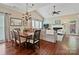 Open-concept living and dining area with hardwood floors, fireplace, and a vaulted ceiling at 2516 Middlebridge Ln, Charlotte, NC 28270