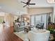 Spacious living area with hardwood floors, a ceiling fan, and large windows for ample natural light at 2516 Middlebridge Ln, Charlotte, NC 28270