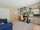 Office featuring a desk, shelves, and comfortable blue sofa at 2516 Middlebridge Ln, Charlotte, NC 28270