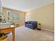Bright office space with large window and blue sofa at 2516 Middlebridge Ln, Charlotte, NC 28270