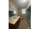 Bathroom with a vanity sink, toilet, and a tub with shower, and a window at 3253 Centergrove Rd, Kannapolis, NC 28083
