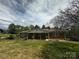 A charming single-story home featuring a brick facade, covered porch, and spacious front yard at 3253 Centergrove Rd, Kannapolis, NC 28083