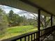 Scenic view from the porch overlooking a lush green field surrounded by trees at 3253 Centergrove Rd, Kannapolis, NC 28083