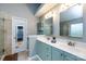 Bathroom featuring a double vanity sink with neutral countertops and stylish green-painted cabinets at 3505 Mayspring Pl, Charlotte, NC 28269