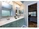 Bathroom featuring a double vanity sink with neutral countertops and stylish green-painted cabinets at 3505 Mayspring Pl, Charlotte, NC 28269