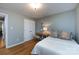 Cozy bedroom featuring neutral walls, a light wood desk, and a white bed with decorative pillows at 3505 Mayspring Pl, Charlotte, NC 28269