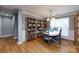 Dining room with wainscoting, built-in bookshelves and hardwood floors at 3505 Mayspring Pl, Charlotte, NC 28269