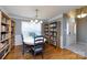 Eat in dining room with wainscoting, built-in bookshelves and hardwood floors at 3505 Mayspring Pl, Charlotte, NC 28269