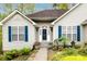 Close up exterior view of the home highlighting the front entrance, blue shutters, and manicured landscaping at 3505 Mayspring Pl, Charlotte, NC 28269