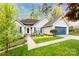 Inviting exterior view featuring siding, manicured lawn, and vibrant landscaping with colorful flowers and shrubs at 3505 Mayspring Pl, Charlotte, NC 28269