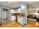 Bright kitchen featuring stainless steel appliances, light cabinets, and a view into the living room at 3505 Mayspring Pl, Charlotte, NC 28269