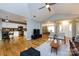 Spacious living room featuring hardwood floors, vaulted ceilings, and an open floor plan to the kitchen and dining area at 3505 Mayspring Pl, Charlotte, NC 28269