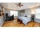 A spacious main bedroom with a ceiling fan, a desk, and bright windows at 3505 Mayspring Pl, Charlotte, NC 28269